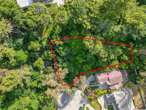 an aerial view of a house with a yard