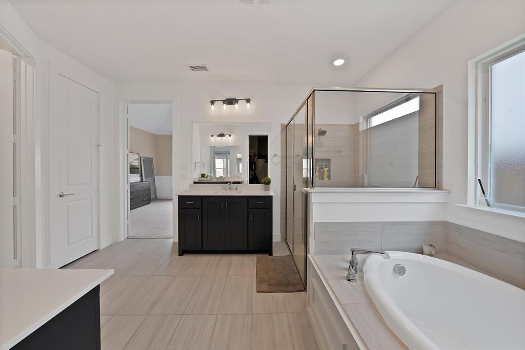 1010 Adair Road Prosper, TX 75078 - Photo 15 of 39 a spacious bathroom with a tub sink and mirror