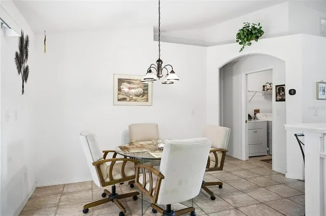 a view of a dining room with furniture and a chandelier