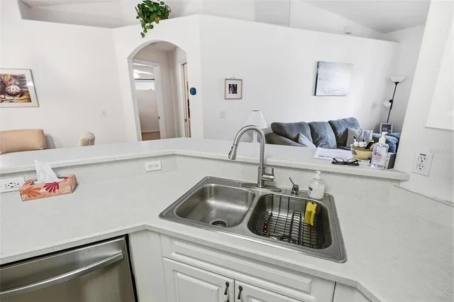 a kitchen with white cabinets and white appliances