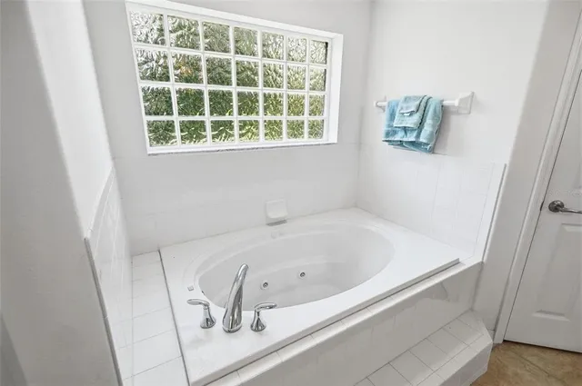 a view of a kitchen with fridge and workspace