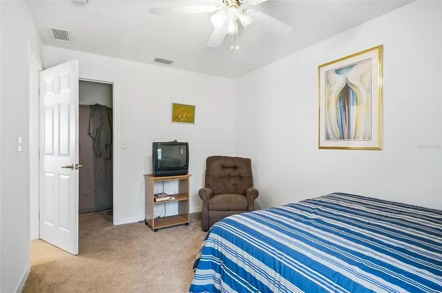 a bathroom with a double vanity sink a toilet and shower