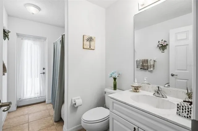 a spacious bedroom with a bed and a chandelier