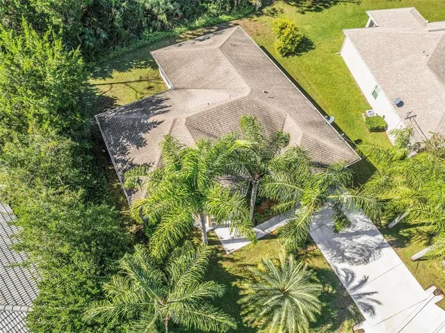 an aerial view of a house with swimming pool and garden