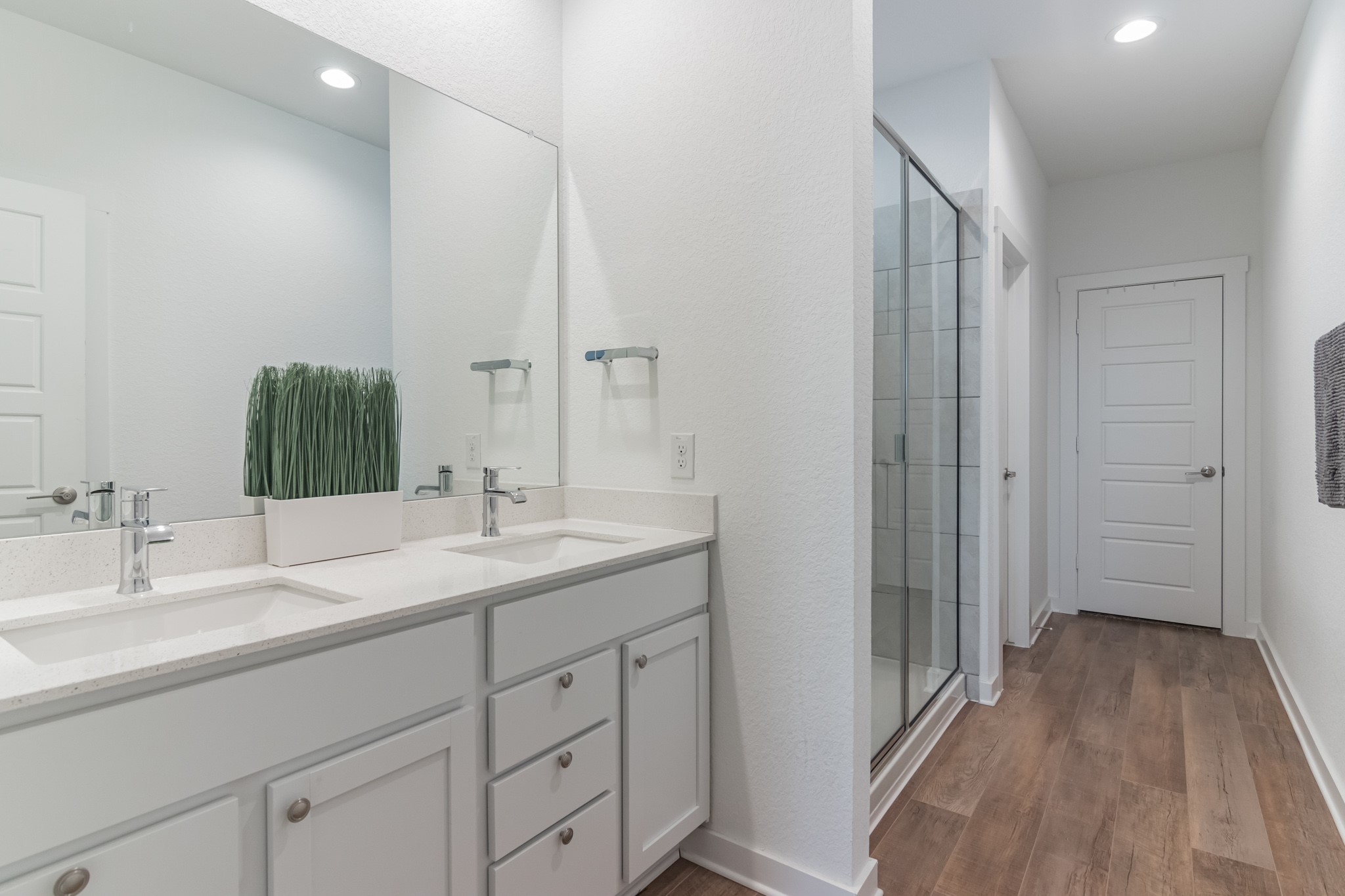 116 Century Plant Road Leander, TX 78641 - Photo 26 of 30 A spacious double vanity and a glass-enclosed shower highlight this modern primary bathroom.