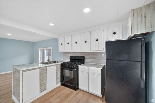 200 North Harrisville Road, Unit 37 Ogden, UT 84404 - Photo 5 of 14 Kitchen with black appliances, a peninsula, light countertops, light wood-style flooring, and recessed lighting