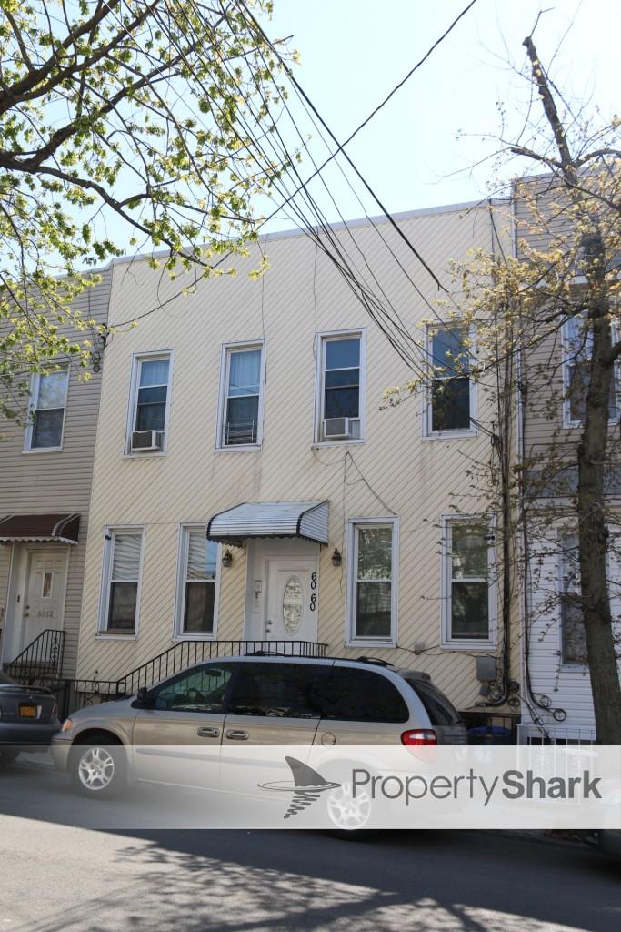 60-60 56th Street, Unit 2R Queens, NY 11378 - Photo 1 of 1 a front view of a building with lot of cars and trees
