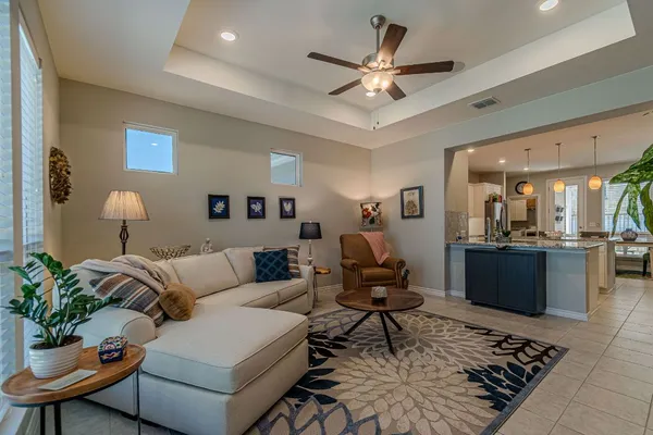 a living room with furniture and a chandelier