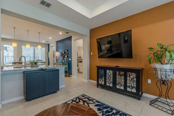 a open kitchen with stainless steel appliances granite countertop a stove a sink and a microwave