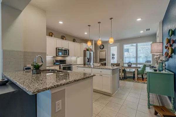 a kitchen with sink cabinets and living room view