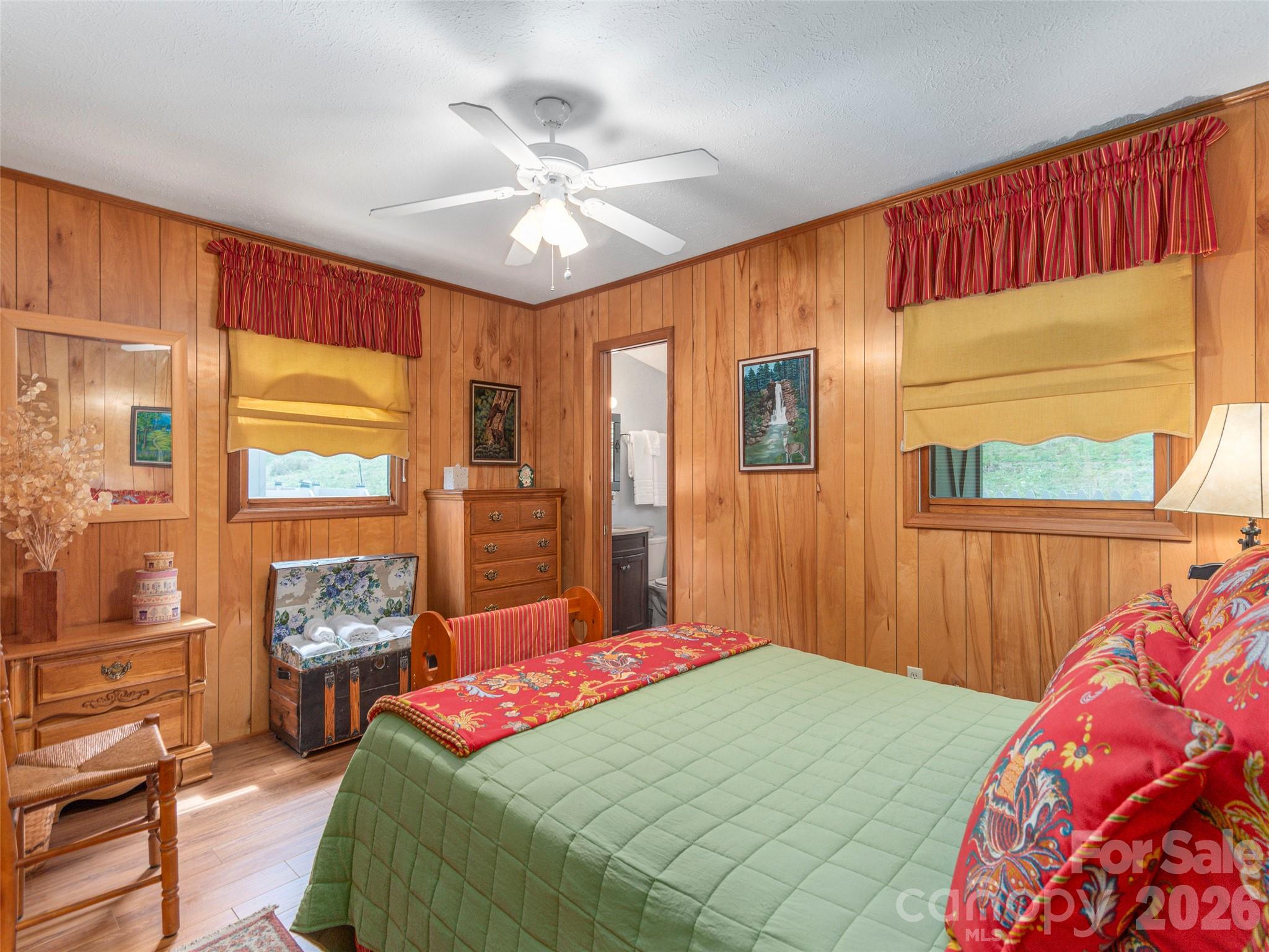 21 Flint Lane Maggie Valley, NC 28751 - Photo 14 of 30 a bedroom with a large bed and a chandelier