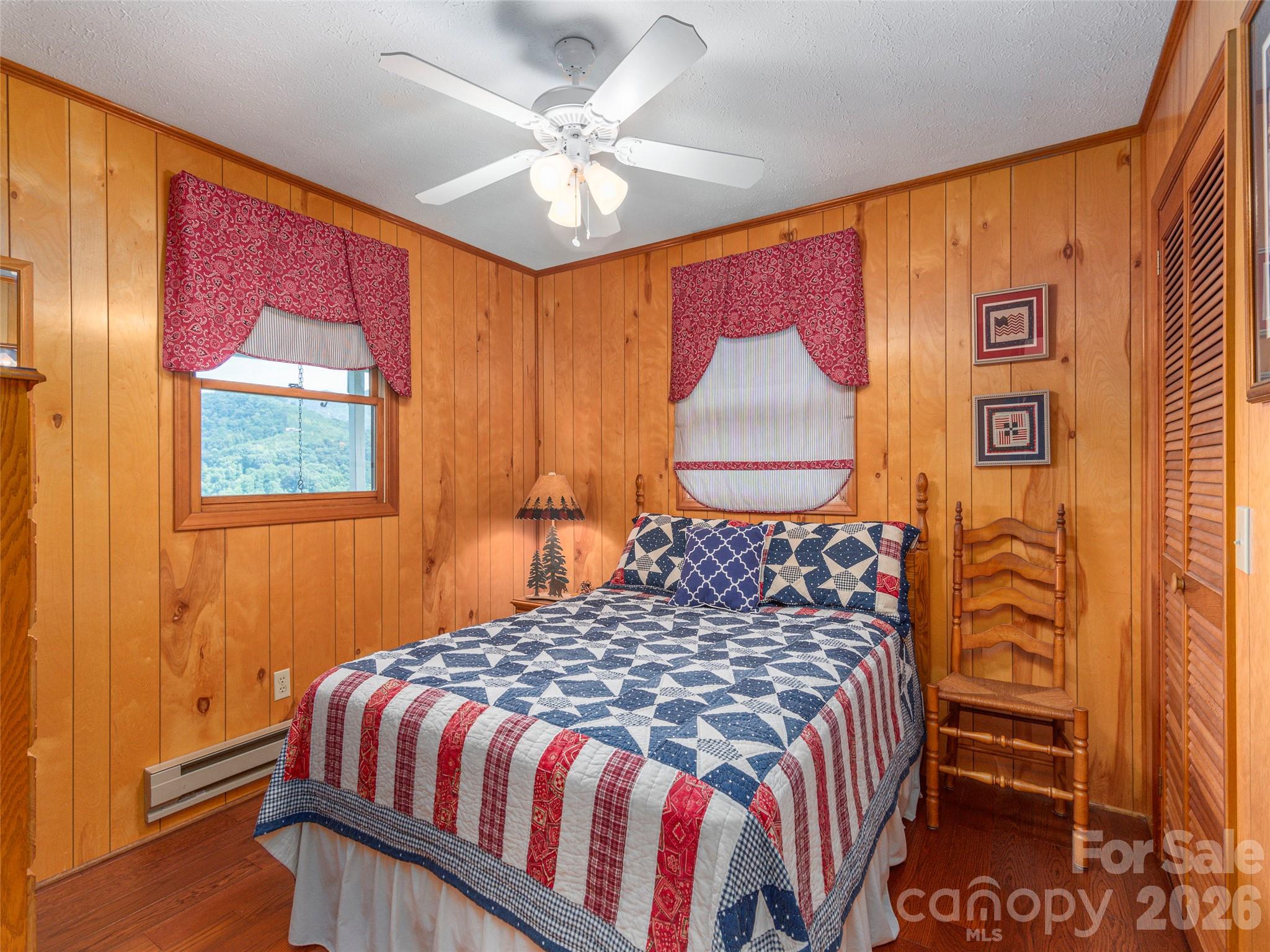 21 Flint Lane Maggie Valley, NC 28751 - Photo 17 of 30 a bedroom with a bed and a chandelier