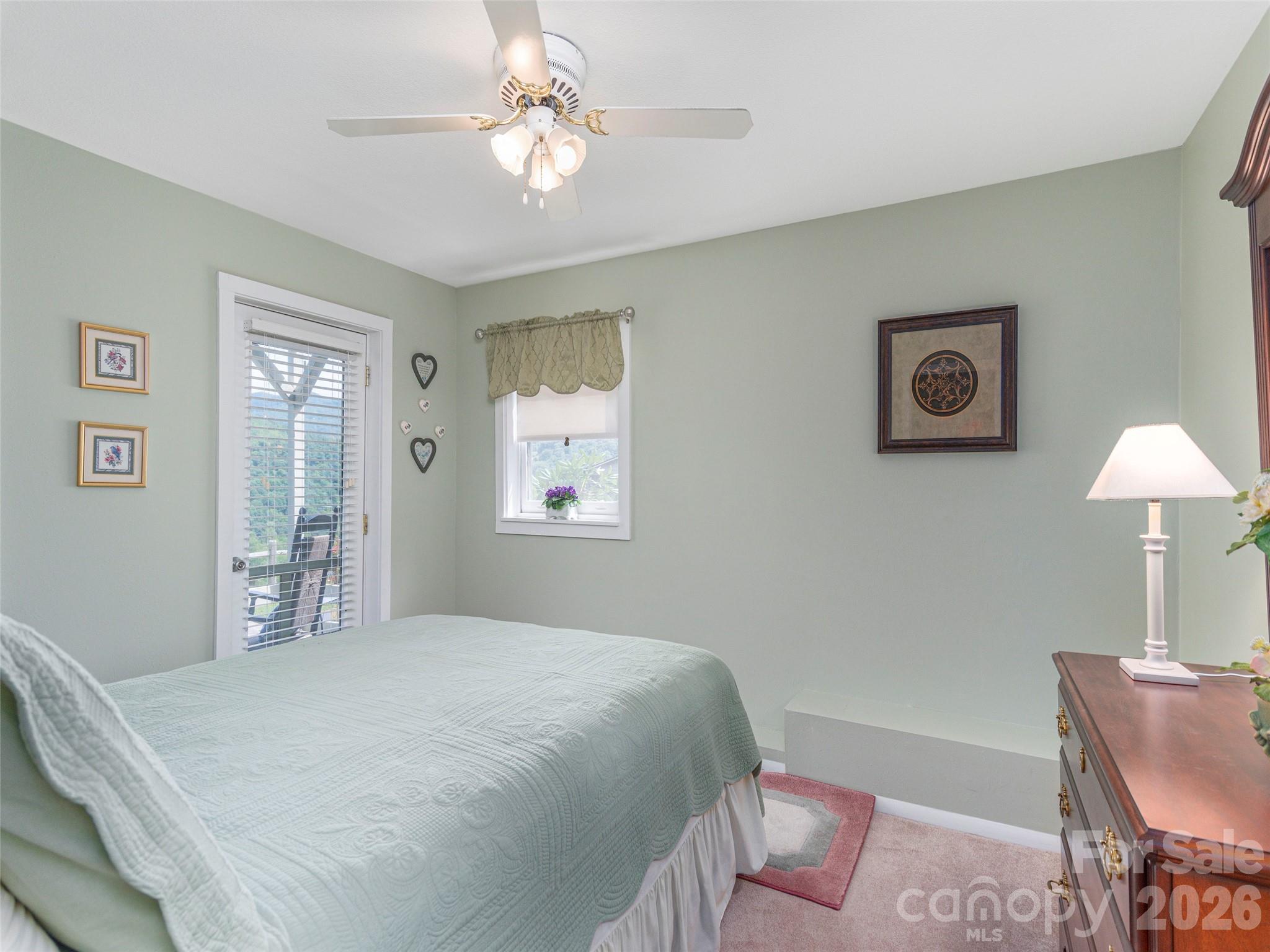 21 Flint Lane Maggie Valley, NC 28751 - Photo 21 of 30 a bedroom with a bed and a chair