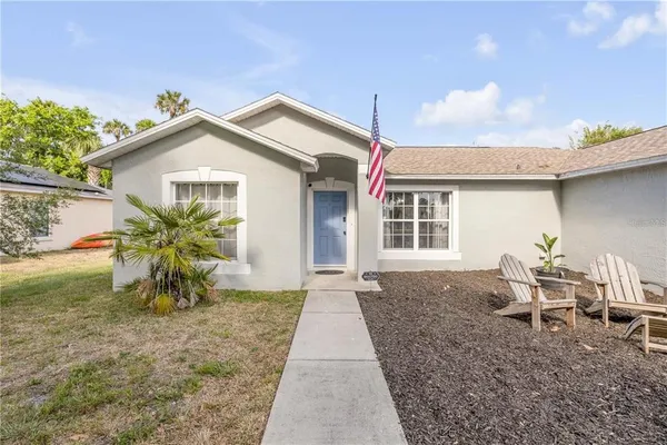 a view of a house with a yard and sitting area
