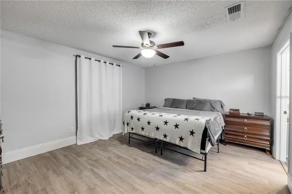 a bedroom with a bed and a ceiling fan