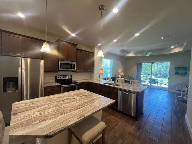 a kitchen with a sink and a stove top oven