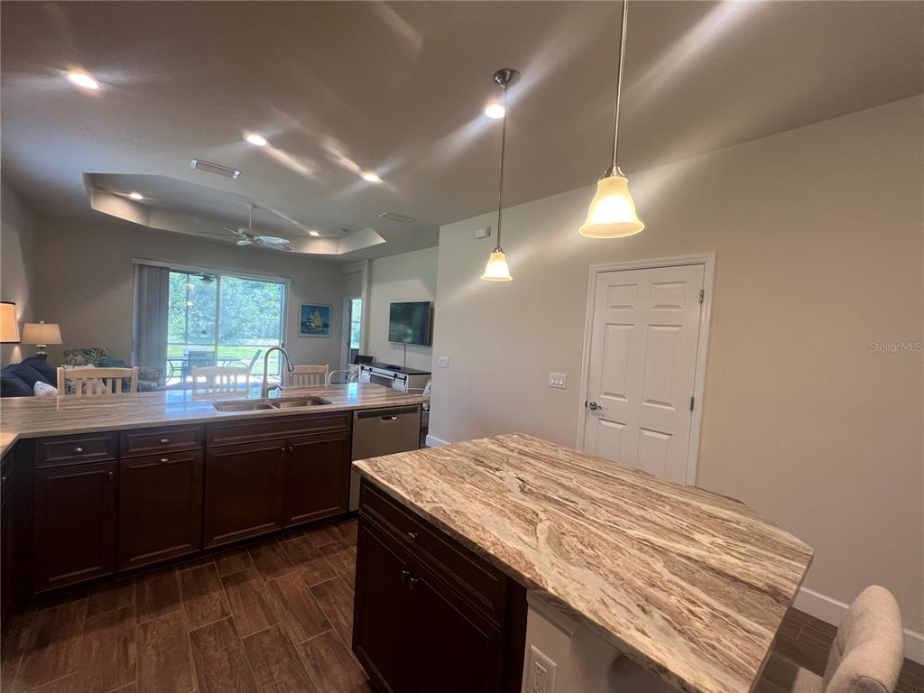 9912 Sheltering Spruce Street Englewood, FL 34223 - Photo 12 of 55 a kitchen with a sink and a stove top oven