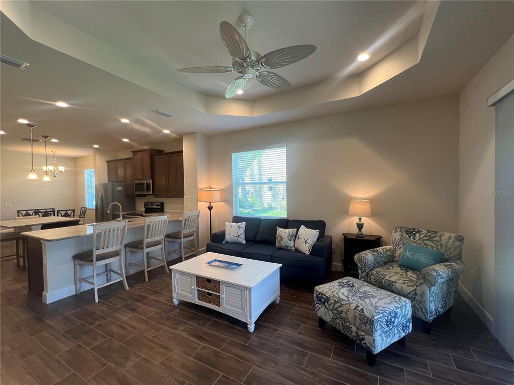 9912 Sheltering Spruce Street Englewood, FL 34223 - Photo 13 of 55 a living room with furniture and a large window