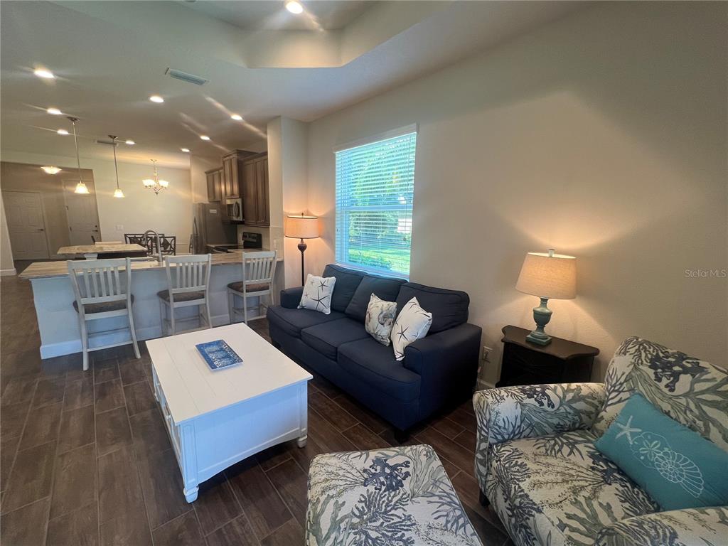 9912 Sheltering Spruce Street Englewood, FL 34223 - Photo 14 of 55 a living room with furniture and view of kitchen