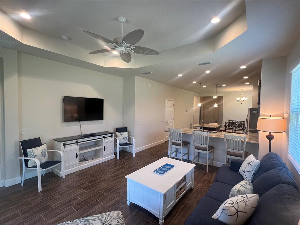 9912 Sheltering Spruce Street Englewood, FL 34223 - Photo 15 of 55 a living room with furniture and a flat screen tv