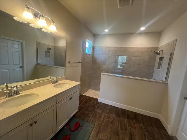 a view of empty room with wooden floor and electronic appliances
