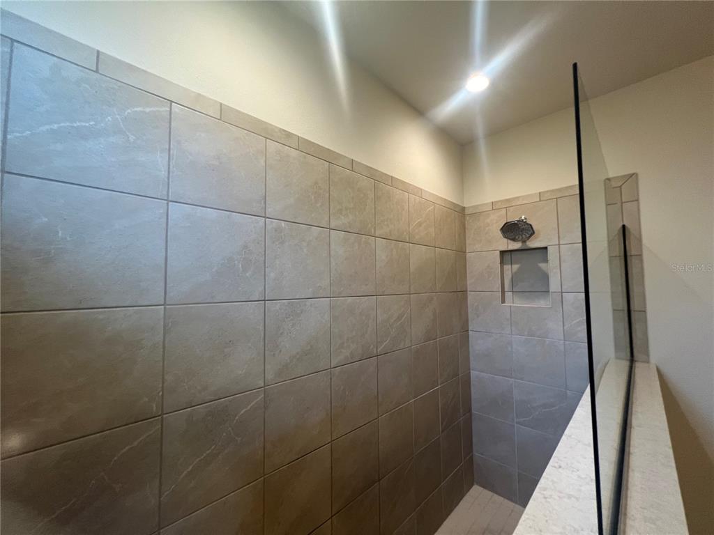 9912 Sheltering Spruce Street Englewood, FL 34223 - Photo 24 of 55 a bathroom with a shower and a glass door