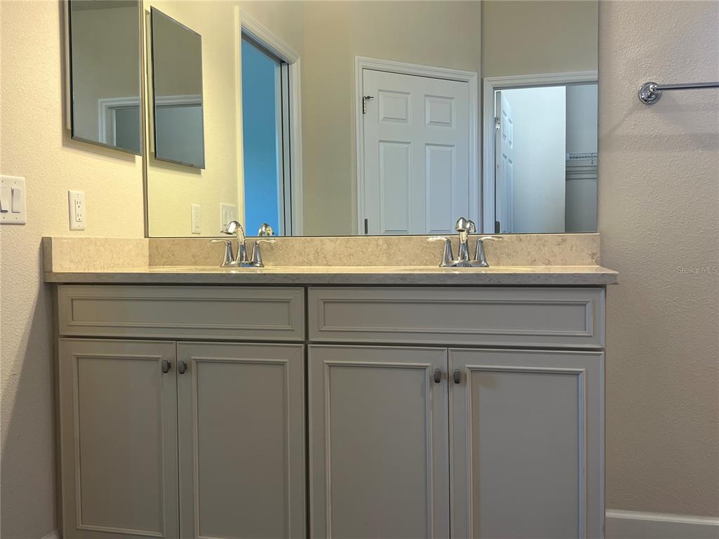 9912 Sheltering Spruce Street Englewood, FL 34223 - Photo 25 of 55 a bathroom with a sink and a mirror