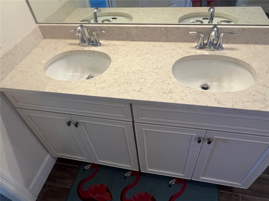 9912 Sheltering Spruce Street Englewood, FL 34223 - Photo 26 of 55 a bathroom with a sink and a mirror