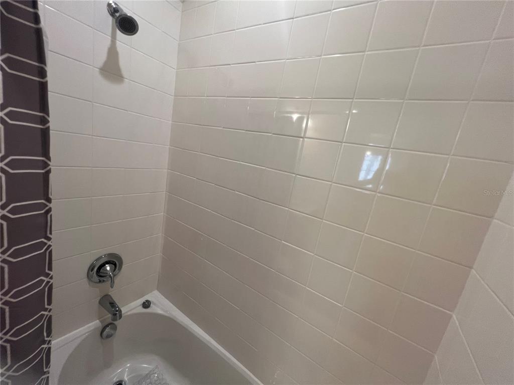 9912 Sheltering Spruce Street Englewood, FL 34223 - Photo 31 of 55 a bathroom with a bathtub