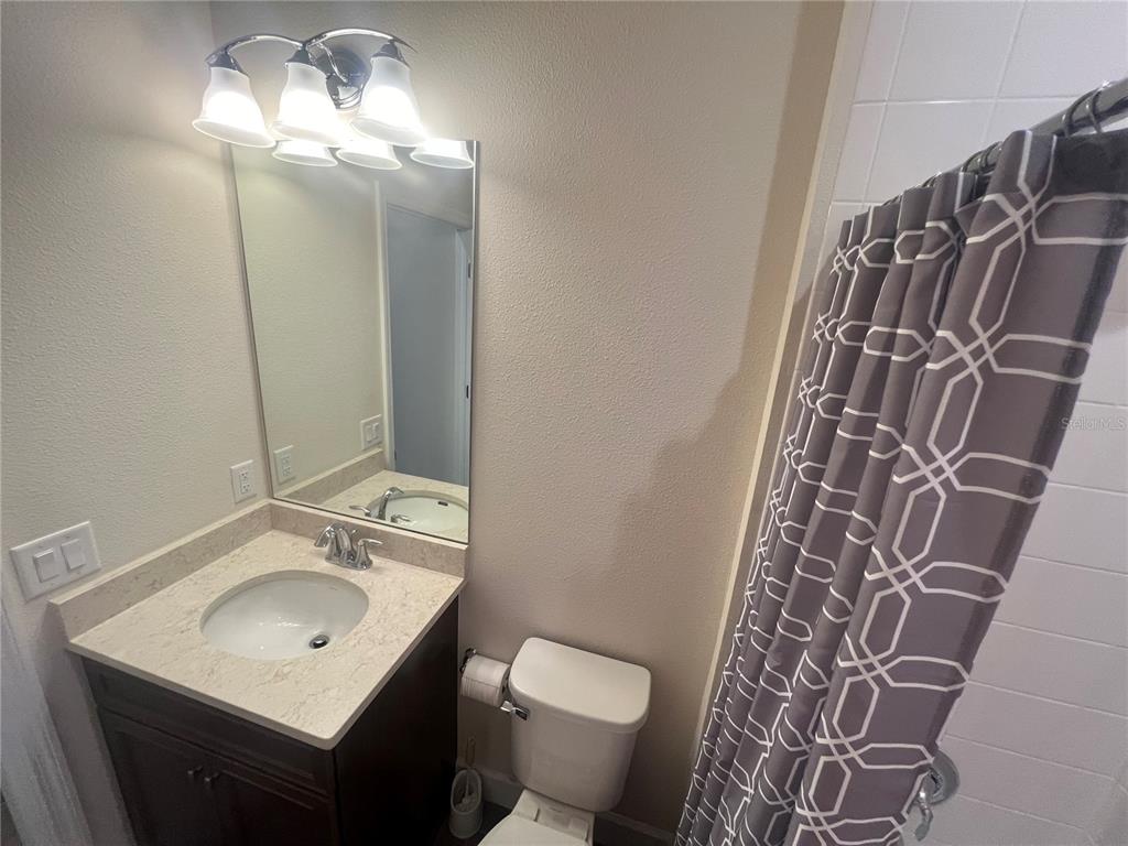 9912 Sheltering Spruce Street Englewood, FL 34223 - Photo 32 of 55 a bathroom with a sink toilet and shower