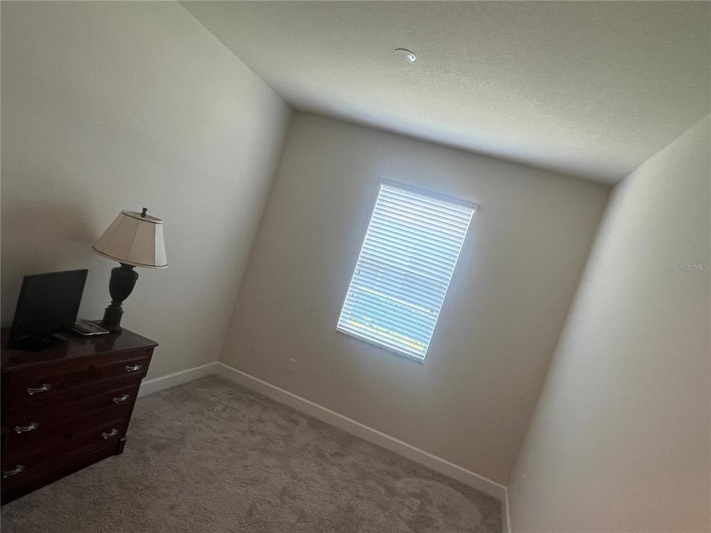 9912 Sheltering Spruce Street Englewood, FL 34223 - Photo 33 of 55 a view of a workspace with furniture and a window