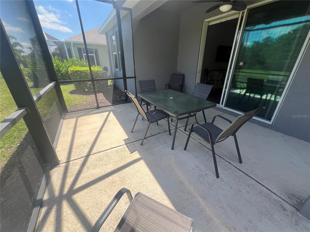 9912 Sheltering Spruce Street Englewood, FL 34223 - Photo 36 of 55 a living room with a couch and a table