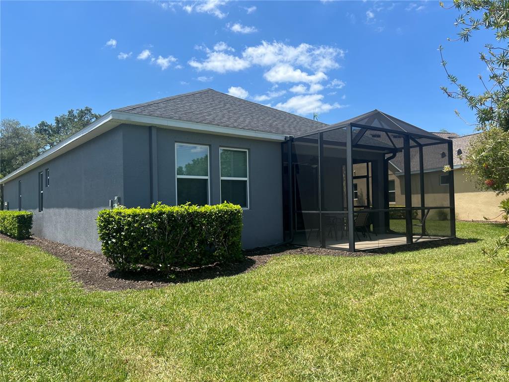 9912 Sheltering Spruce Street Englewood, FL 34223 - Photo 37 of 55 a view of a house with a yard