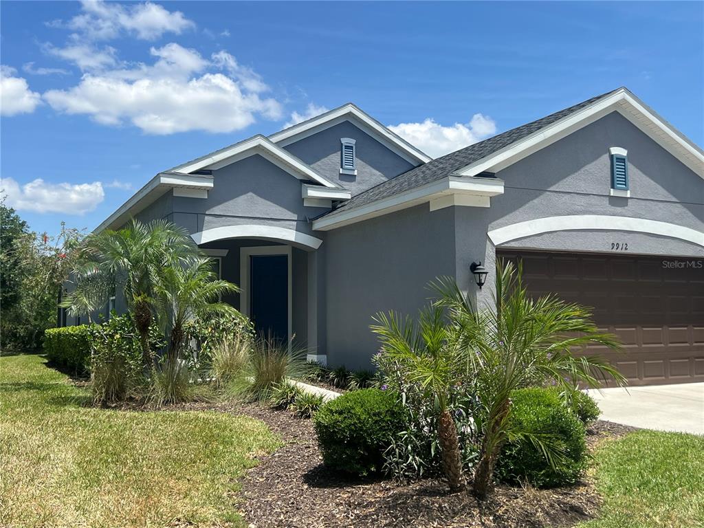 9912 Sheltering Spruce Street Englewood, FL 34223 - Photo 47 of 55 a front view of a house with a garden