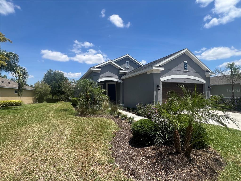 9912 Sheltering Spruce Street Englewood, FL 34223 - Photo 48 of 55 a front view of a house with a yard