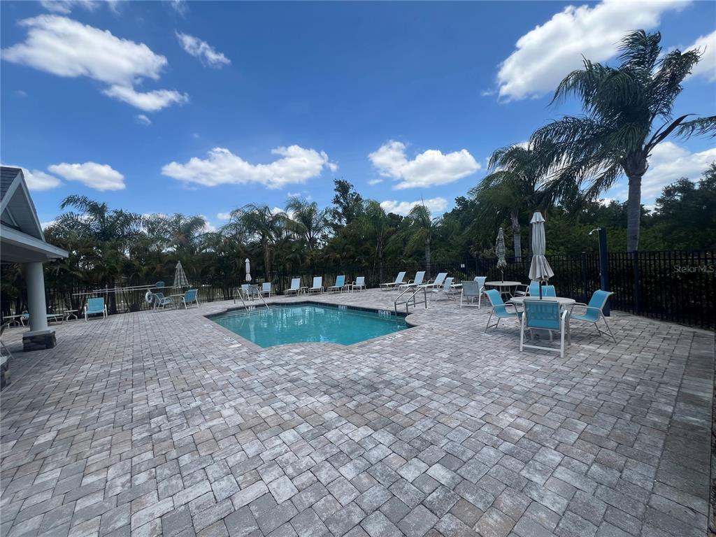 9912 Sheltering Spruce Street Englewood, FL 34223 - Photo 49 of 55 a swimming pool with outdoor seating and yard