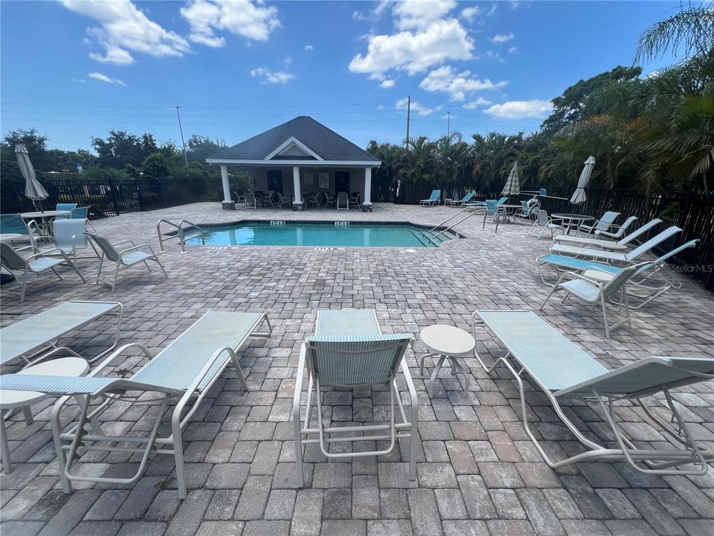 9912 Sheltering Spruce Street Englewood, FL 34223 - Photo 5 of 55 a view of a yard with a table and chairs