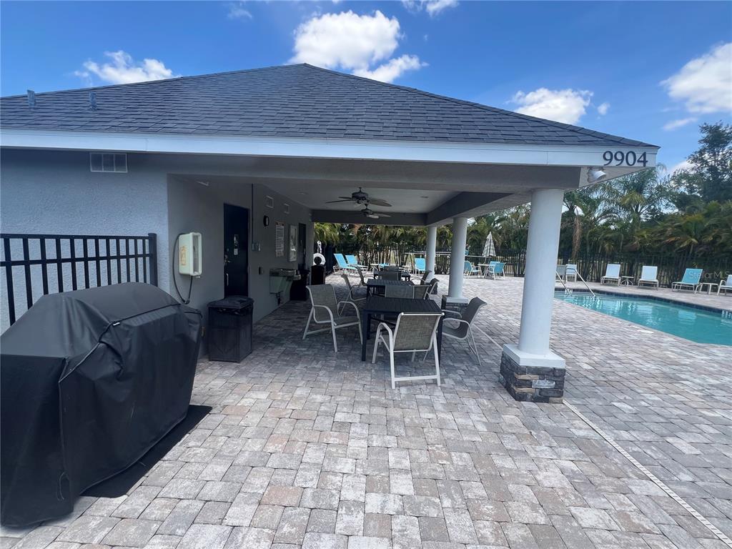 9912 Sheltering Spruce Street Englewood, FL 34223 - Photo 51 of 55 a view of a patio with a table and chairs