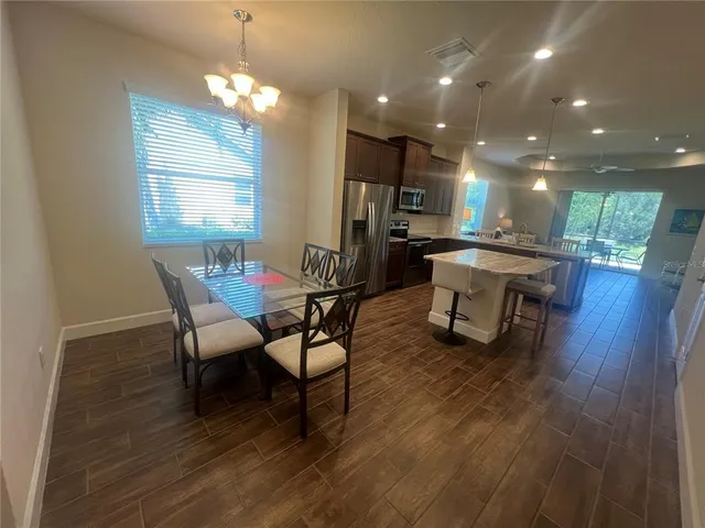 a dining room with furniture and window