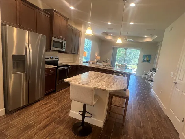 a kitchen with a table chairs and wooden floor