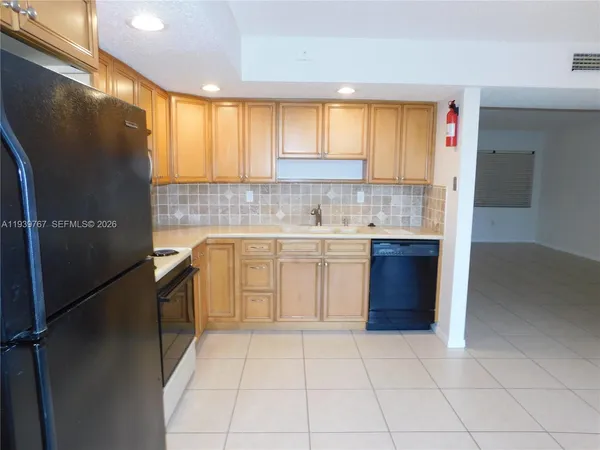 a kitchen with a sink stove and refrigerator