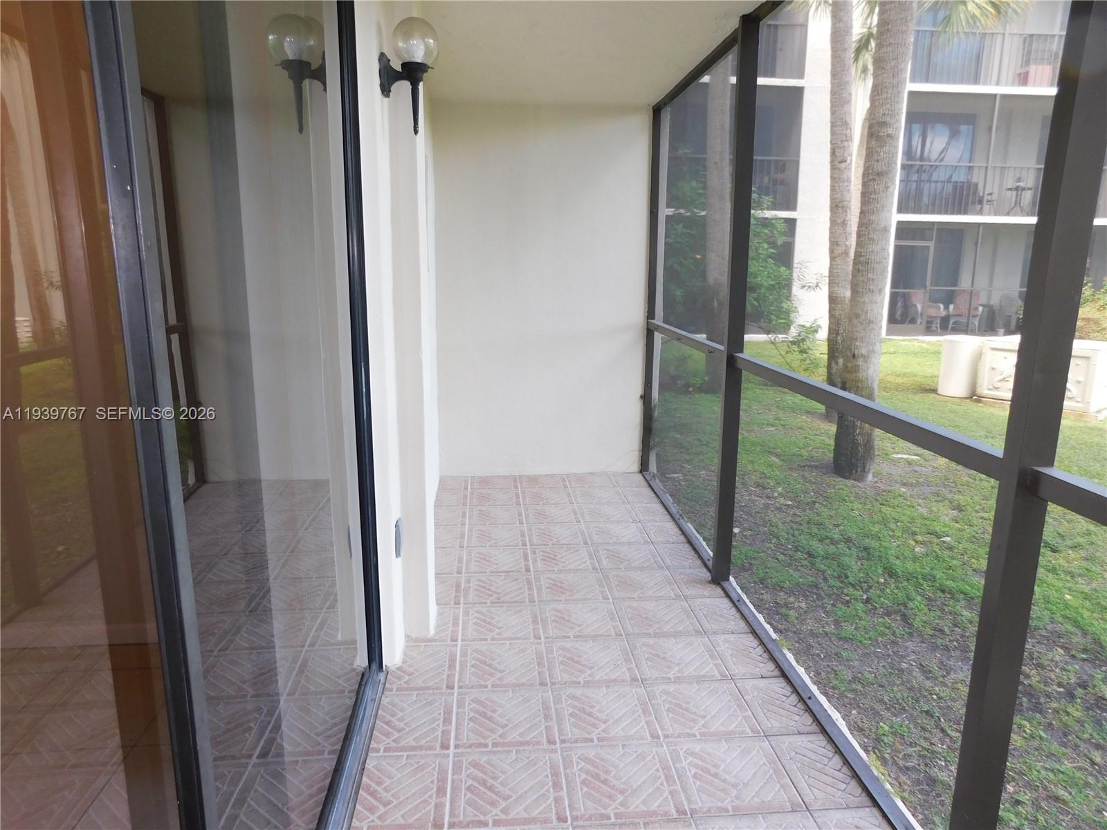 8015 Southwest 107th Avenue, Unit 111 Miami, FL 33173 - Photo 6 of 22 screened balcony (tiled)
