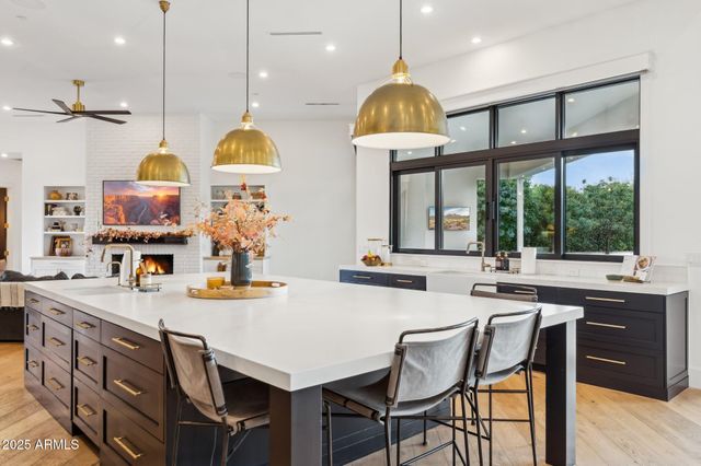 a living room with furniture a fireplace and a large window