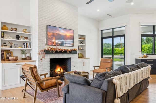 a living room with lots of furniture and kitchen view