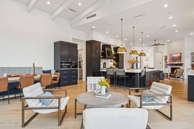 a kitchen with stainless steel appliances granite countertop a sink a stove and a wooden floor