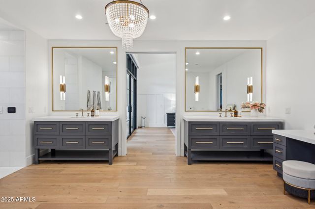 a bathroom with a sink vanity mirror and toilet