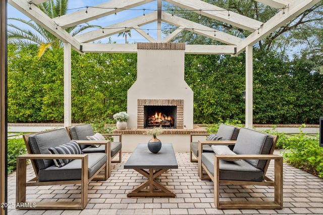 a view of a house with backyard porch and sitting area