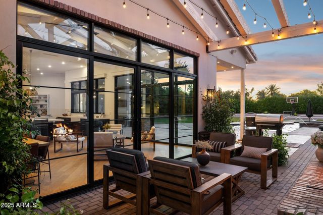 a living room with furniture and a floor to ceiling window
