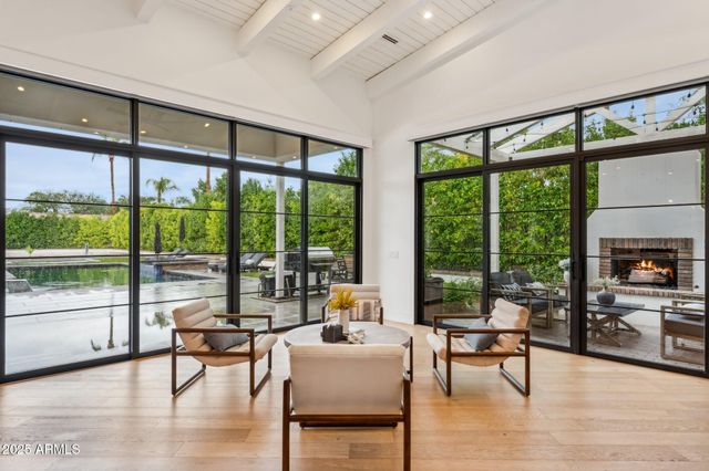 a kitchen with stainless steel appliances granite countertop a sink a stove and a wooden floors