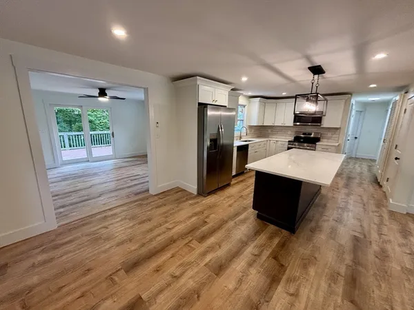 a kitchen with stainless steel appliances a sink a refrigerator and microwave